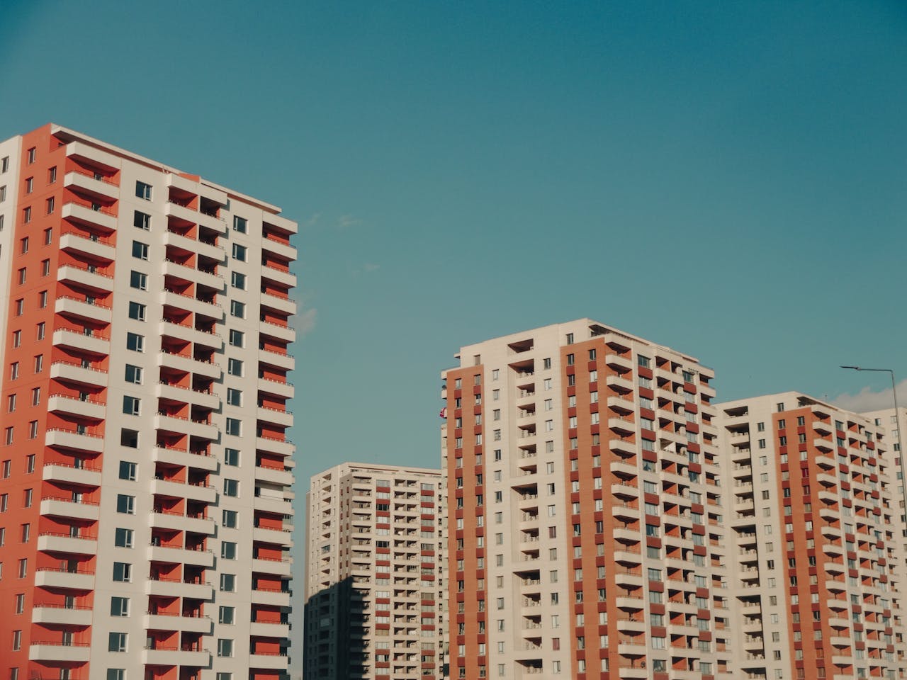 Captivating view of modern high-rise apartment buildings under a clear blue sky.