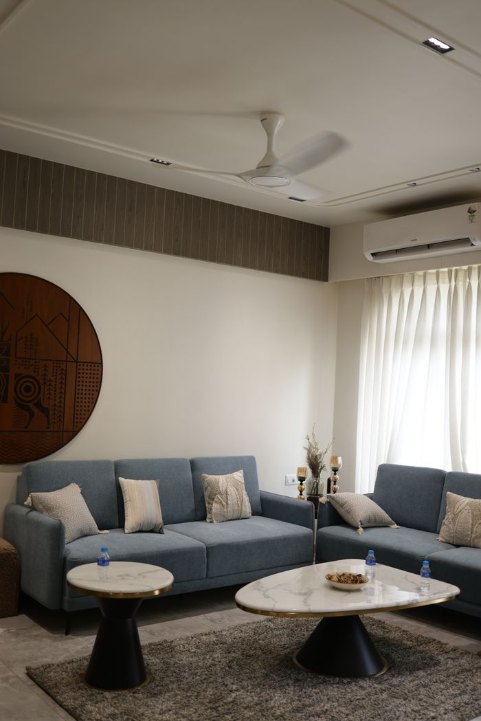 Modern living room with stylish sofas, marble tables, and minimal decor.