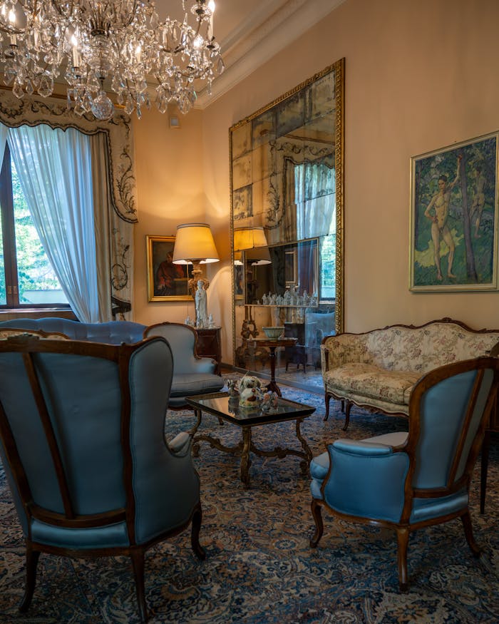 Elegant Milano living room with vintage decor, ornate furniture, and a crystal chandelier.
